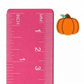 Pumpkin outline stud earring beside an inch and centimeter ruler for size reference