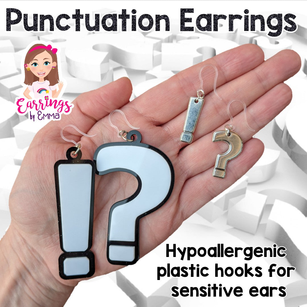 Various punctuation earrings - size comparison hand