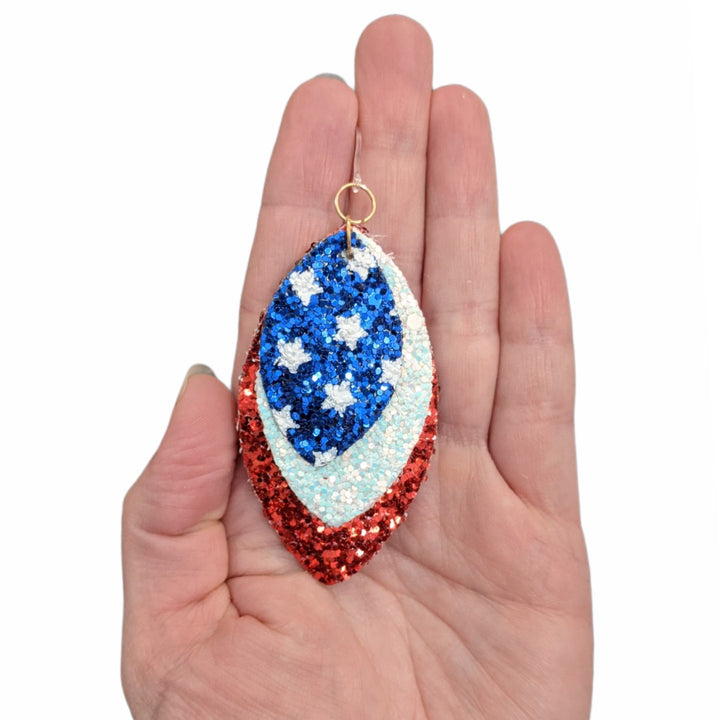 Glitter America Earrings (Dangles) - triple layer teardrop - size comparison hand