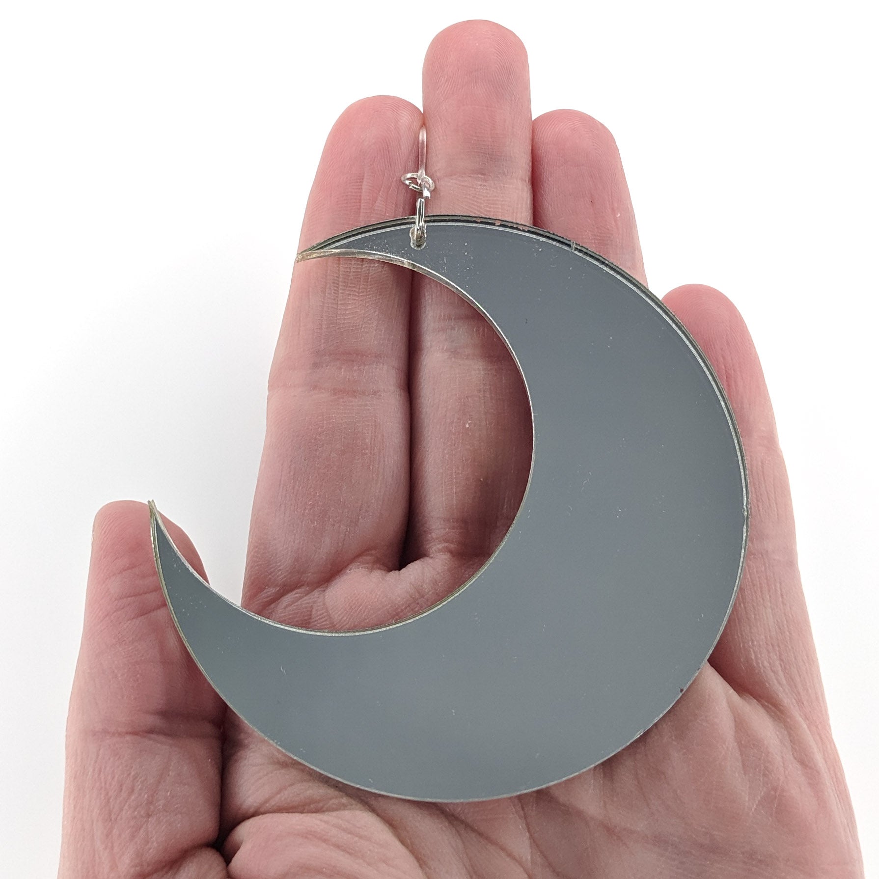 Mirrored Moon Earrings (Dangles) - size comparison hand