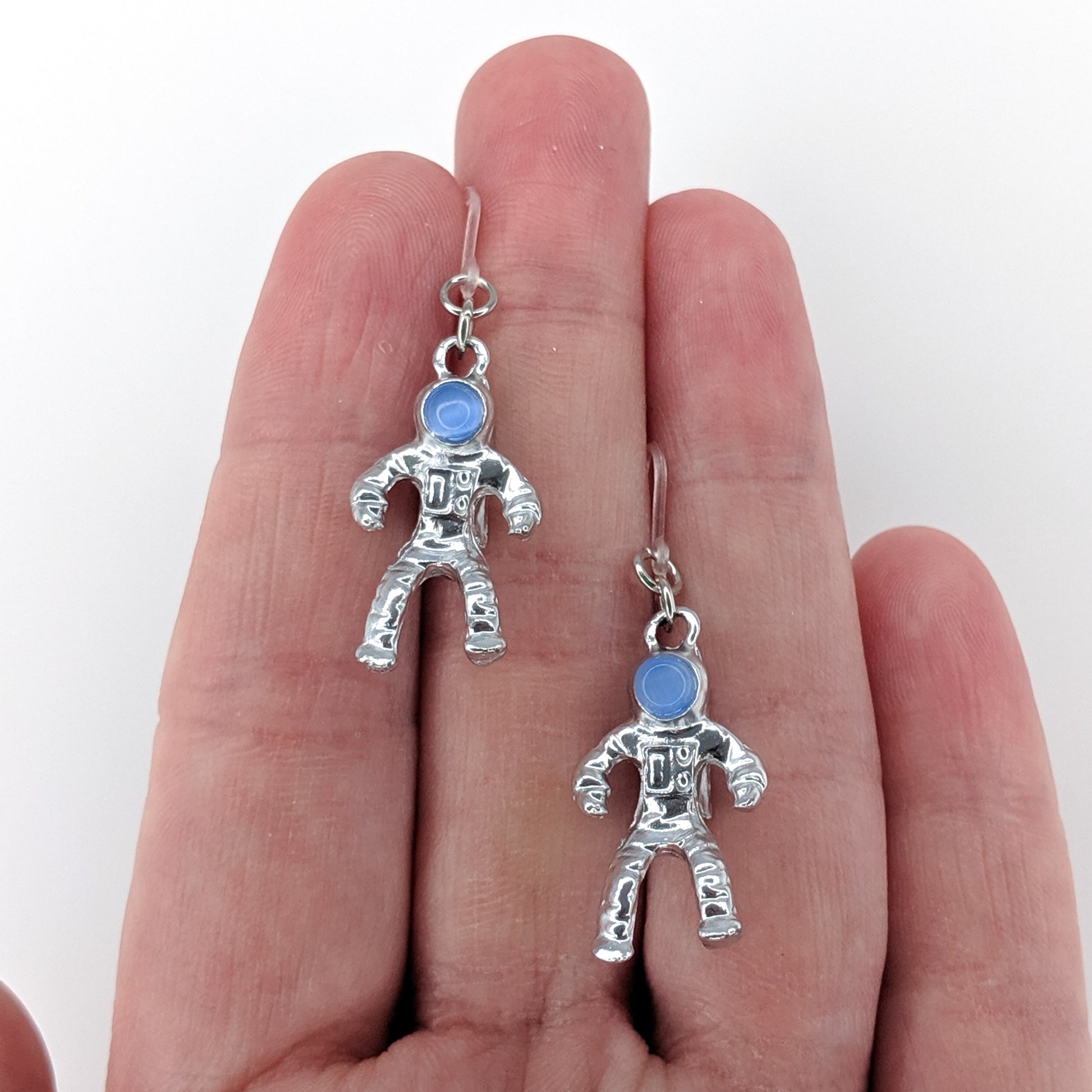 Metallic Astronaut Earrings (Dangles) - size comparison hand