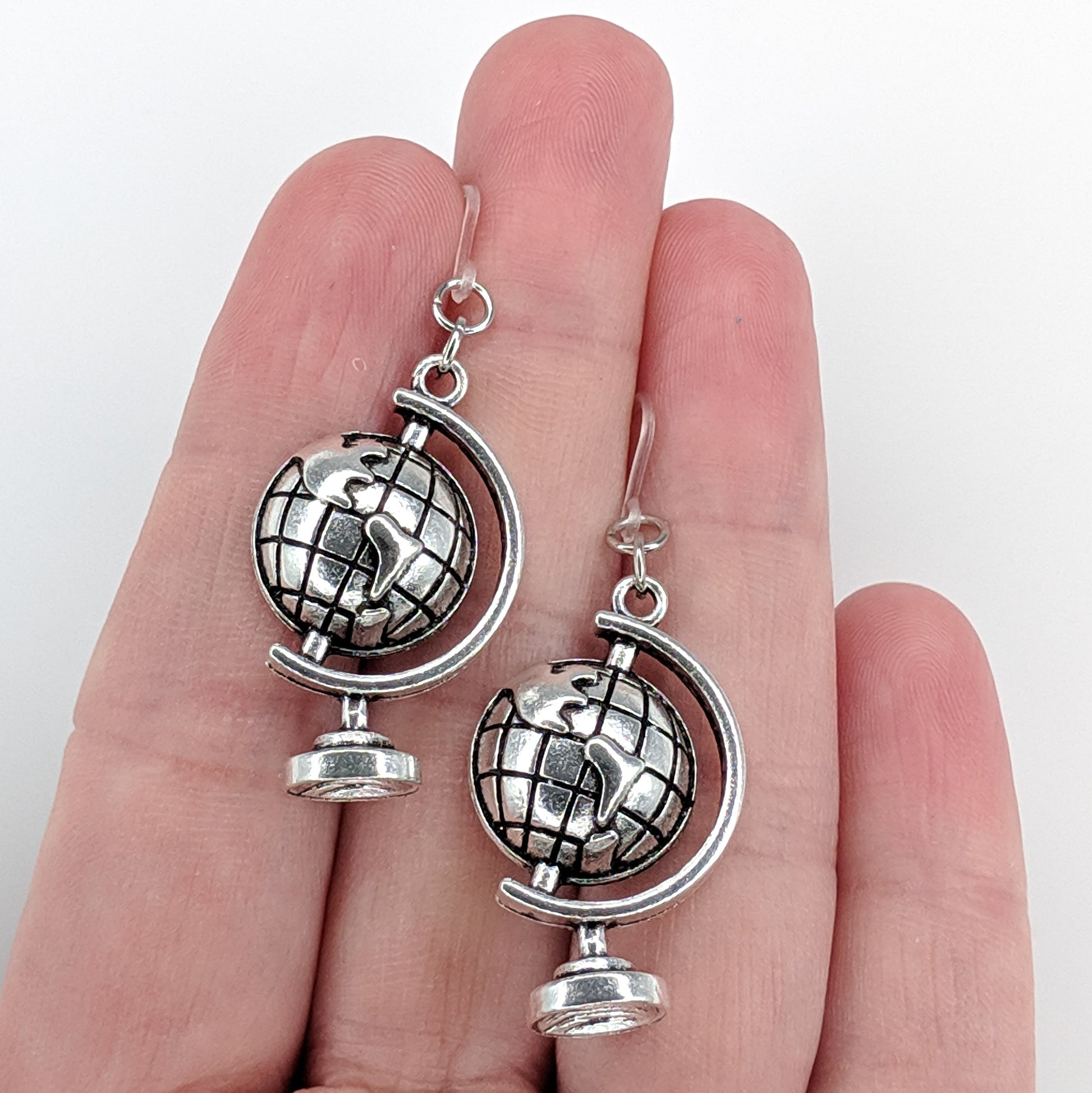 Globe Earrings (Dangles) - size comparison hand