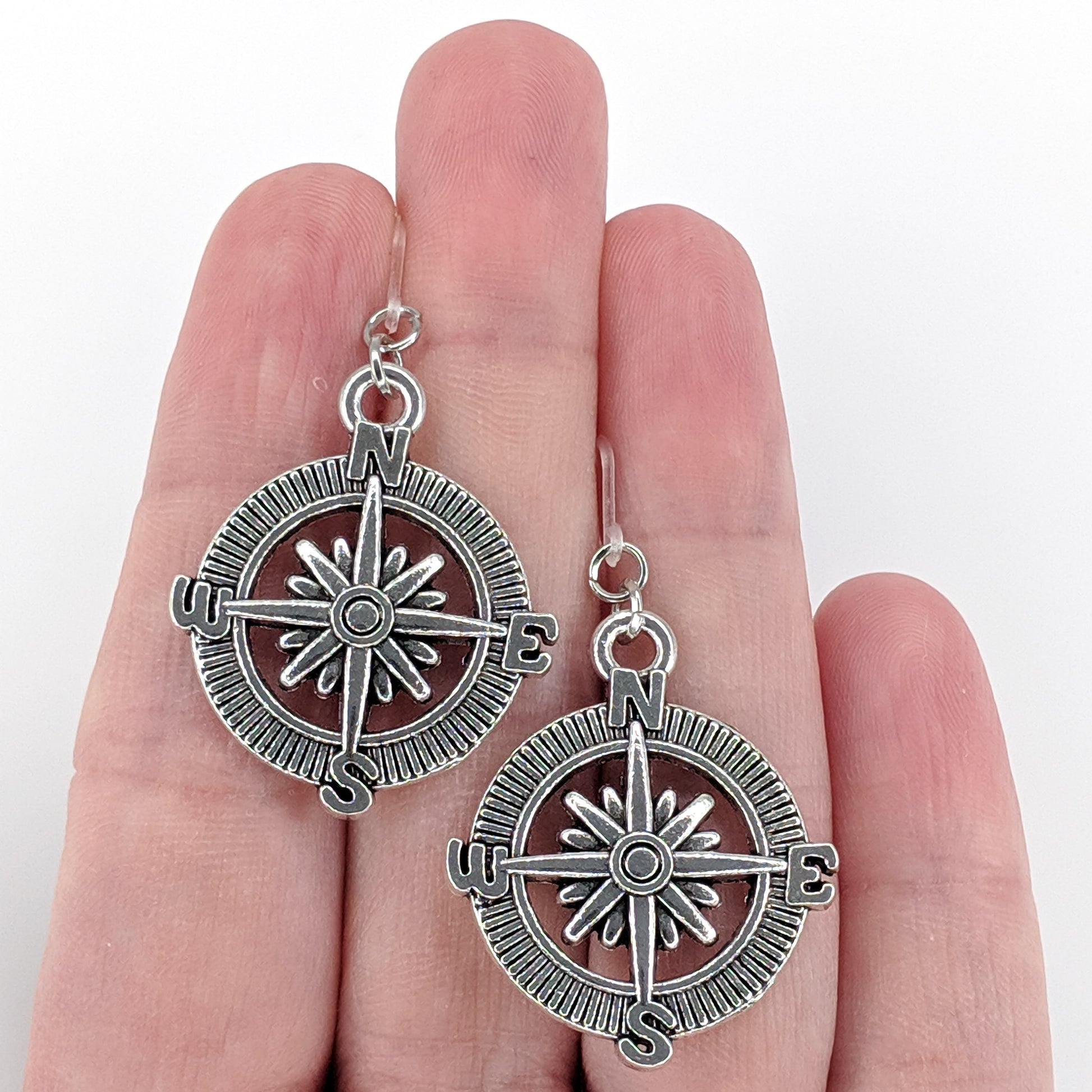 Compass Rose Earrings (Dangles) - size comparison hand