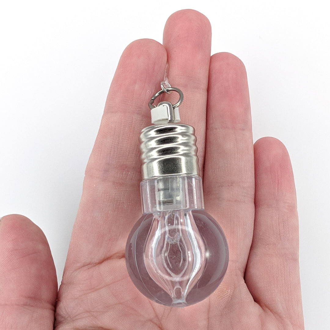 Flashing Light Bulb Earrings (Dangles) - size comparison hand