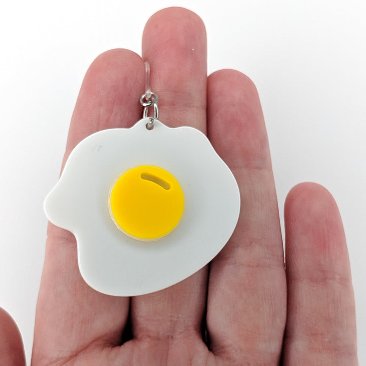 Exaggerated Fried Egg Earrings (Dangles) - size comparison hand