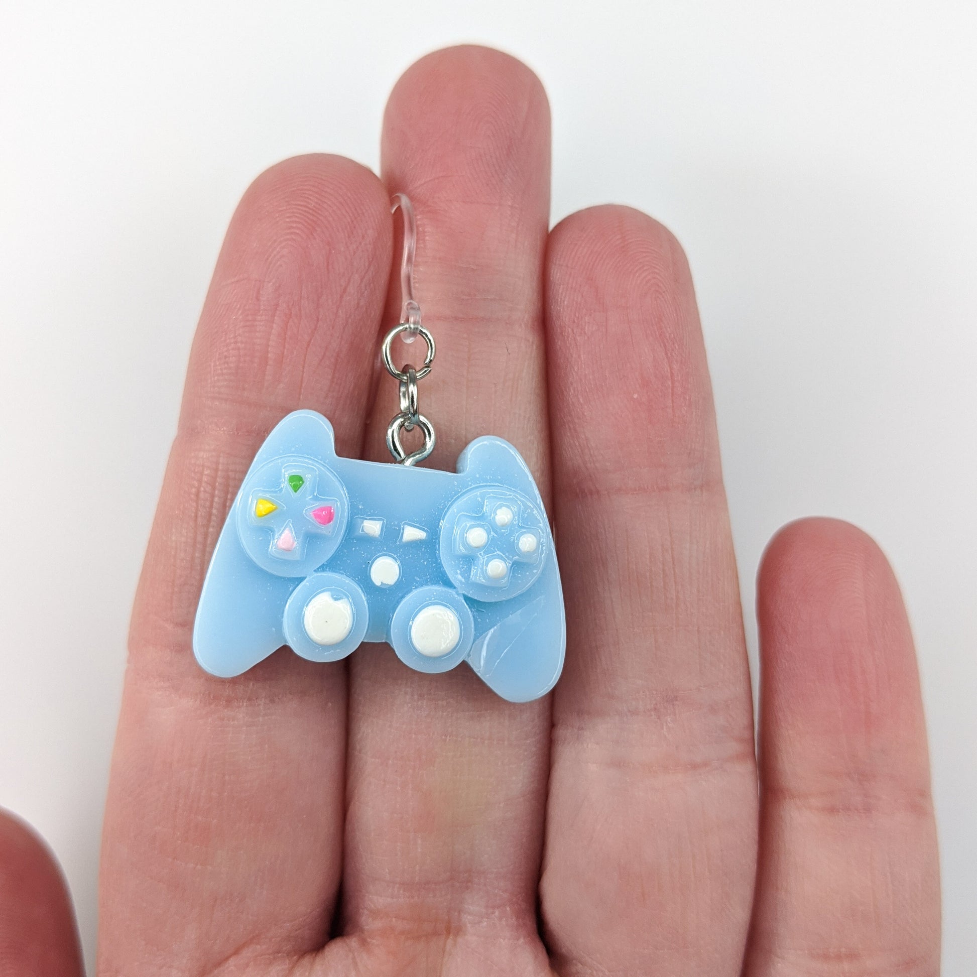 Exaggerated Game Controller Earrings (Dangles) - size comparison hand
