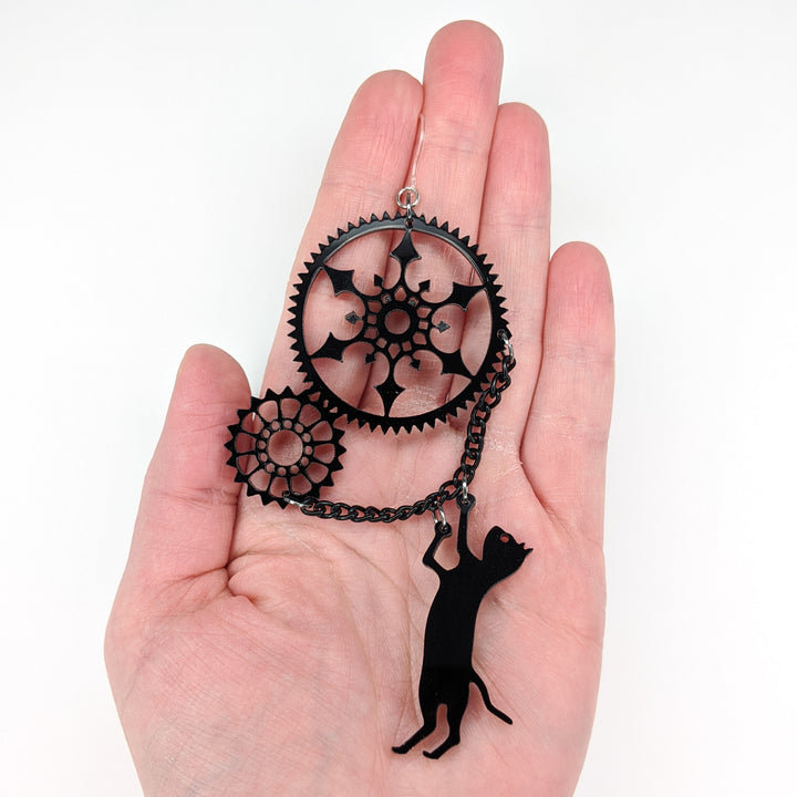 Exaggerated Gear Cat Earrings (Dangles) - size comparison hand