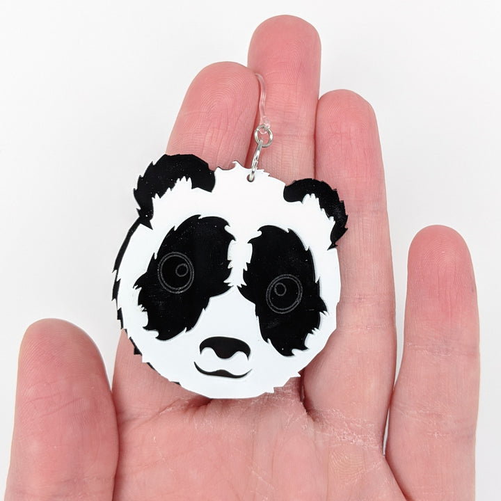 Exaggerated Panda Earrings (Dangles) - size comparison hand