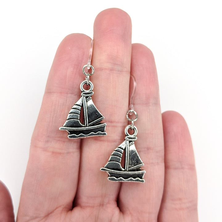 Silver Sailboat Earrings (Dangles) - size comparison hand