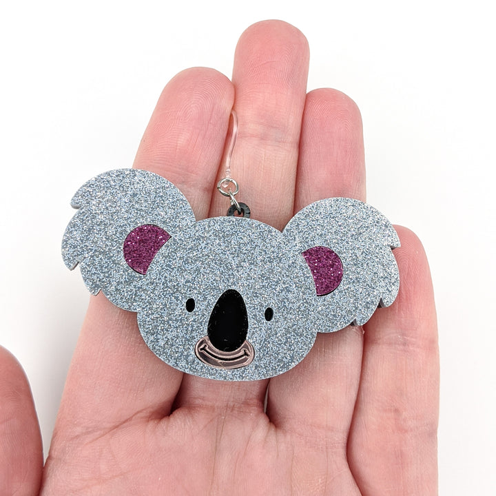 Exaggerated Koala Earrings (Dangles) - size comparison hand