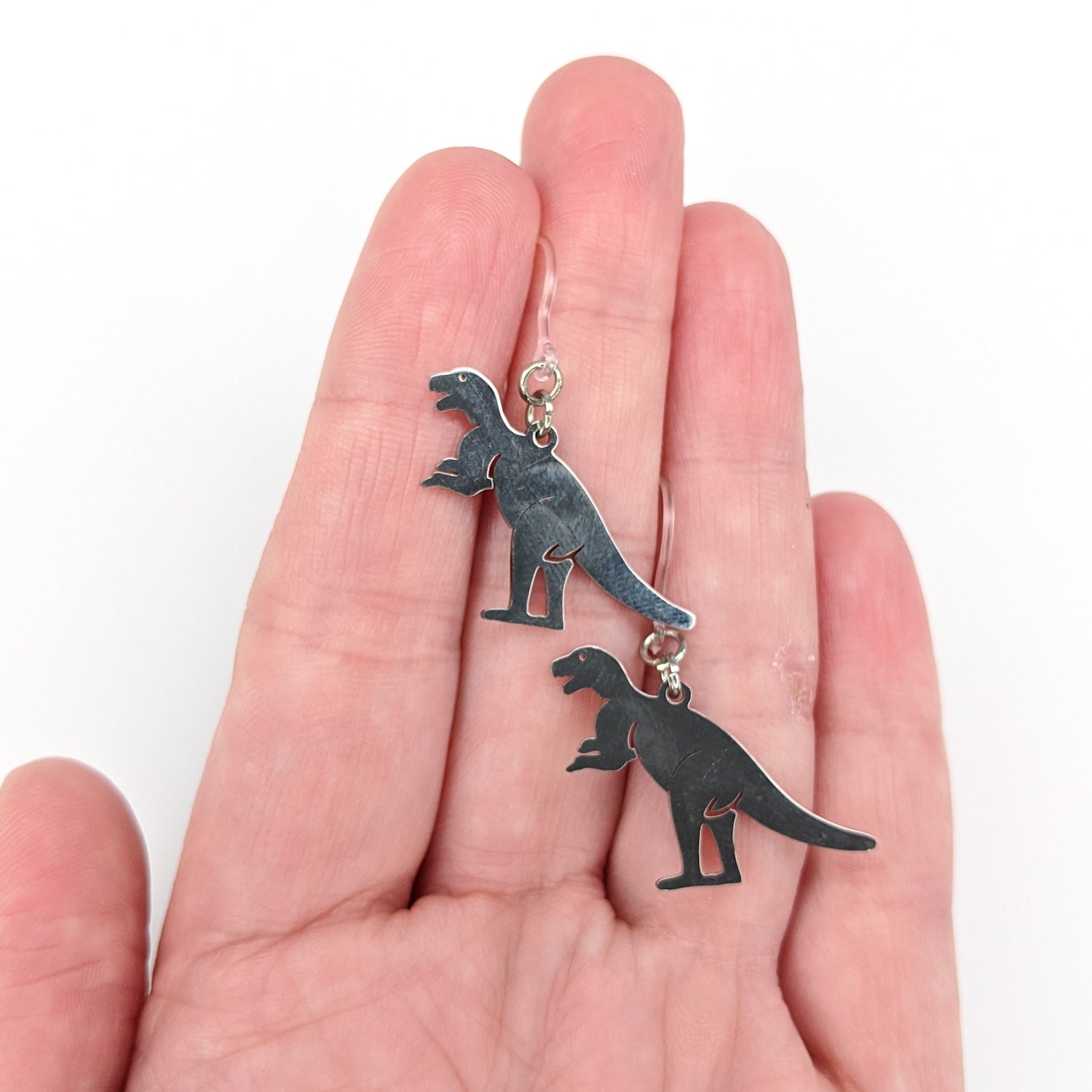 Metallic T-Rex Earrings (Dangles) - size comparison hand
