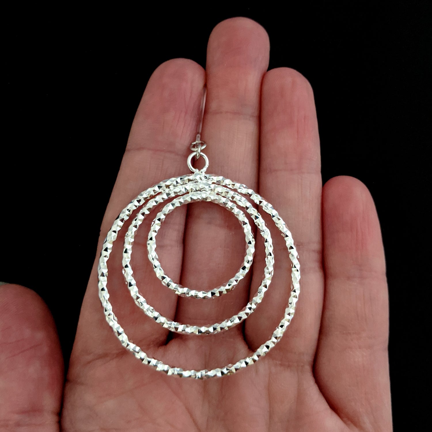 Silver Stacked Hoop Earrings (Dangles) - size comparison hand