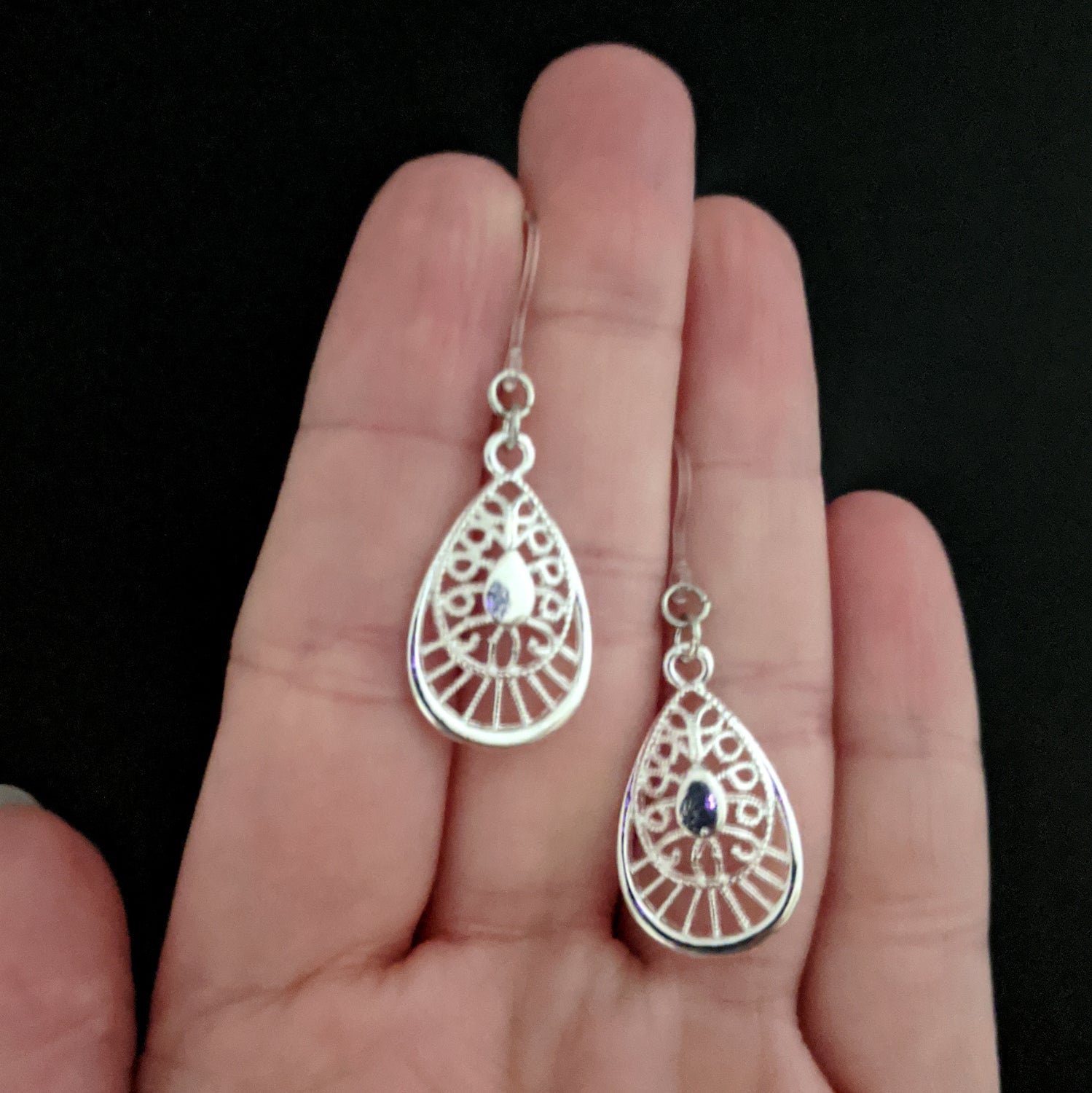 Silver Decorative Teardrop Earrings (Dangles) - size comparison hand