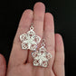 Silver Decorative Flower Earrings (Dangles) - size comparison hand