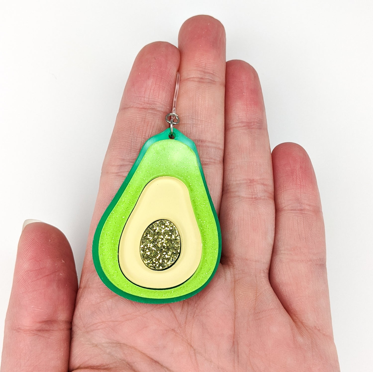 Exaggerated Avocado Earrings (Dangles) - size comparison hand