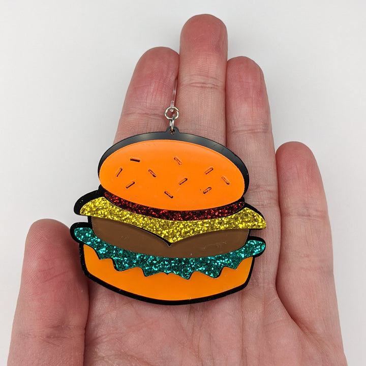 Exaggerated Burger Earrings (Dangles) - size comparison hand