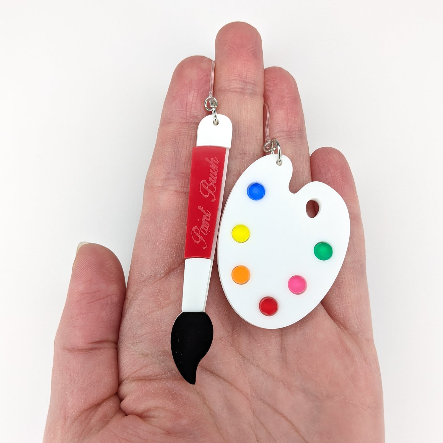 Exaggerated Paint Brush & Palette Earrings (Dangles) - size comparison hand