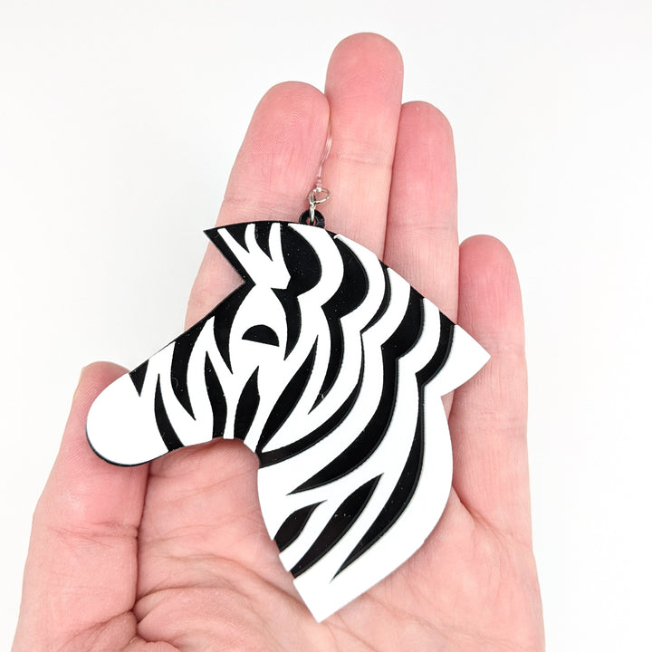 Exaggerated Zebra Earrings (Dangles) - size comparison hand