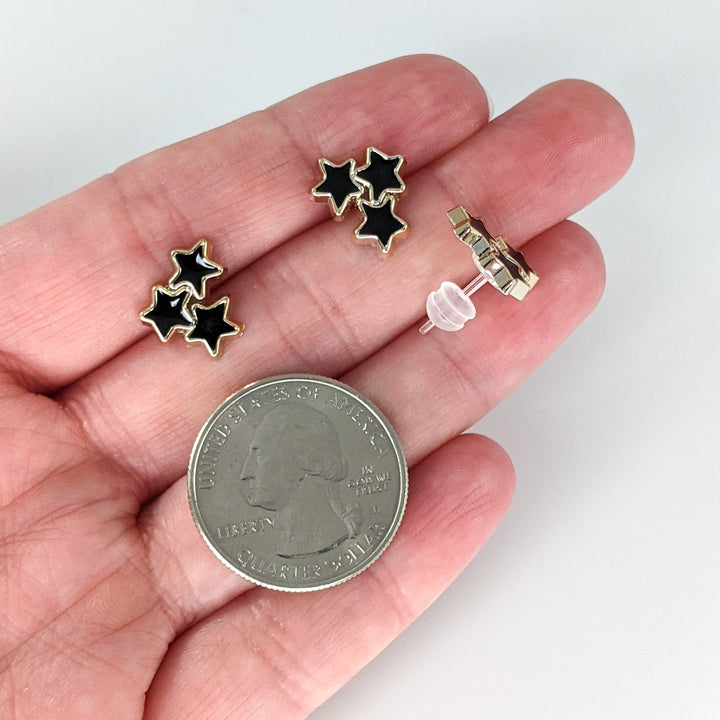 Gold Rimmed Star Cluster Earrings (Studs) - size comparison quarter & hand