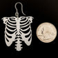Exaggerated Skeleton Ribs Earrings (Dangles) - size comparison quarter
