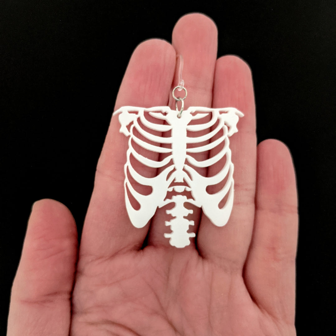 Exaggerated Skeleton Ribs Earrings (Dangles) - size comparison hand