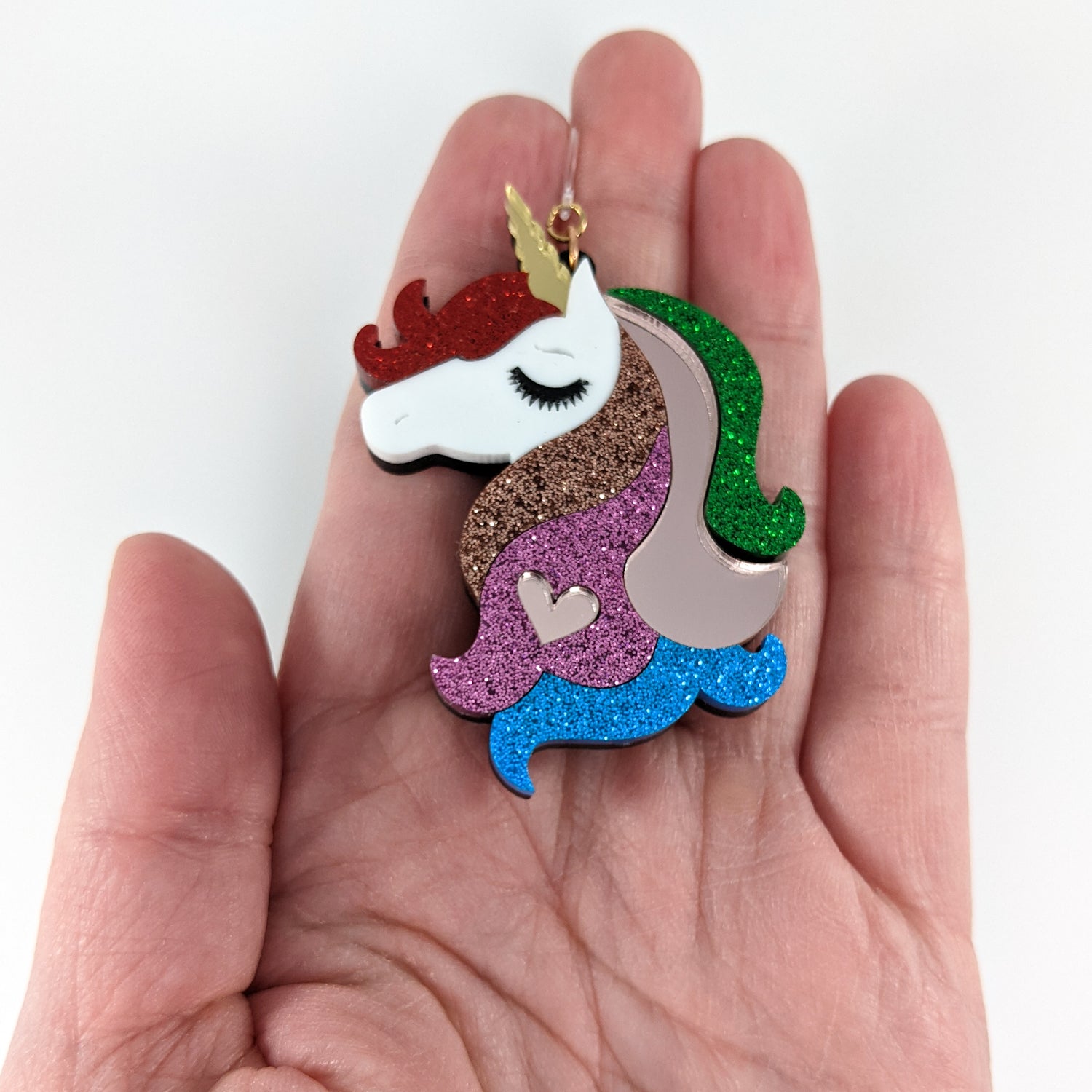 Exaggerated Unicorn Earrings (Dangles) - size comparison hand