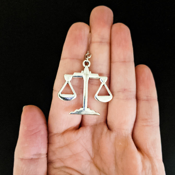 Scales of Justice Earrings (Dangles) - large - size comparison hand
