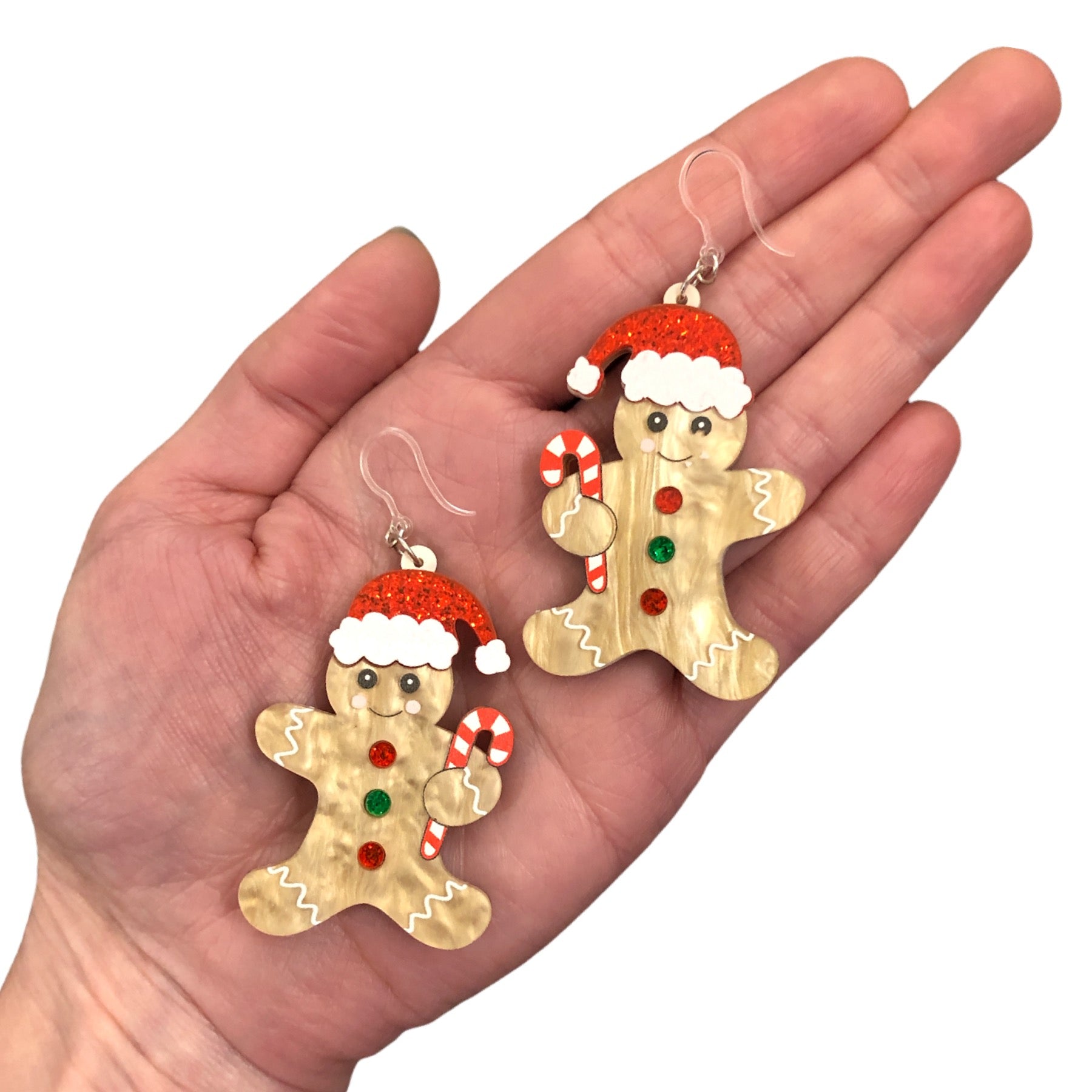 Exaggerated Gingerbread Man Earrings (Dangles) - size comparison hand